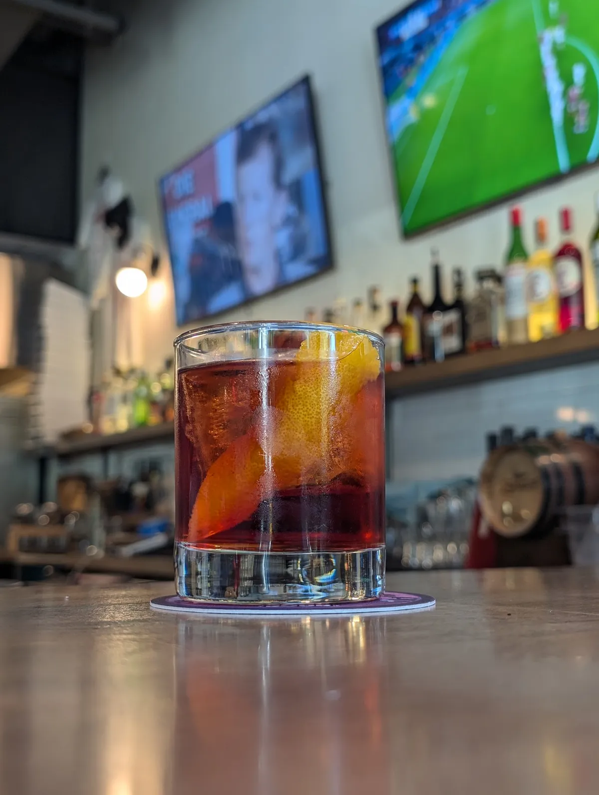 Cocktail with orange peels on a bar counter
